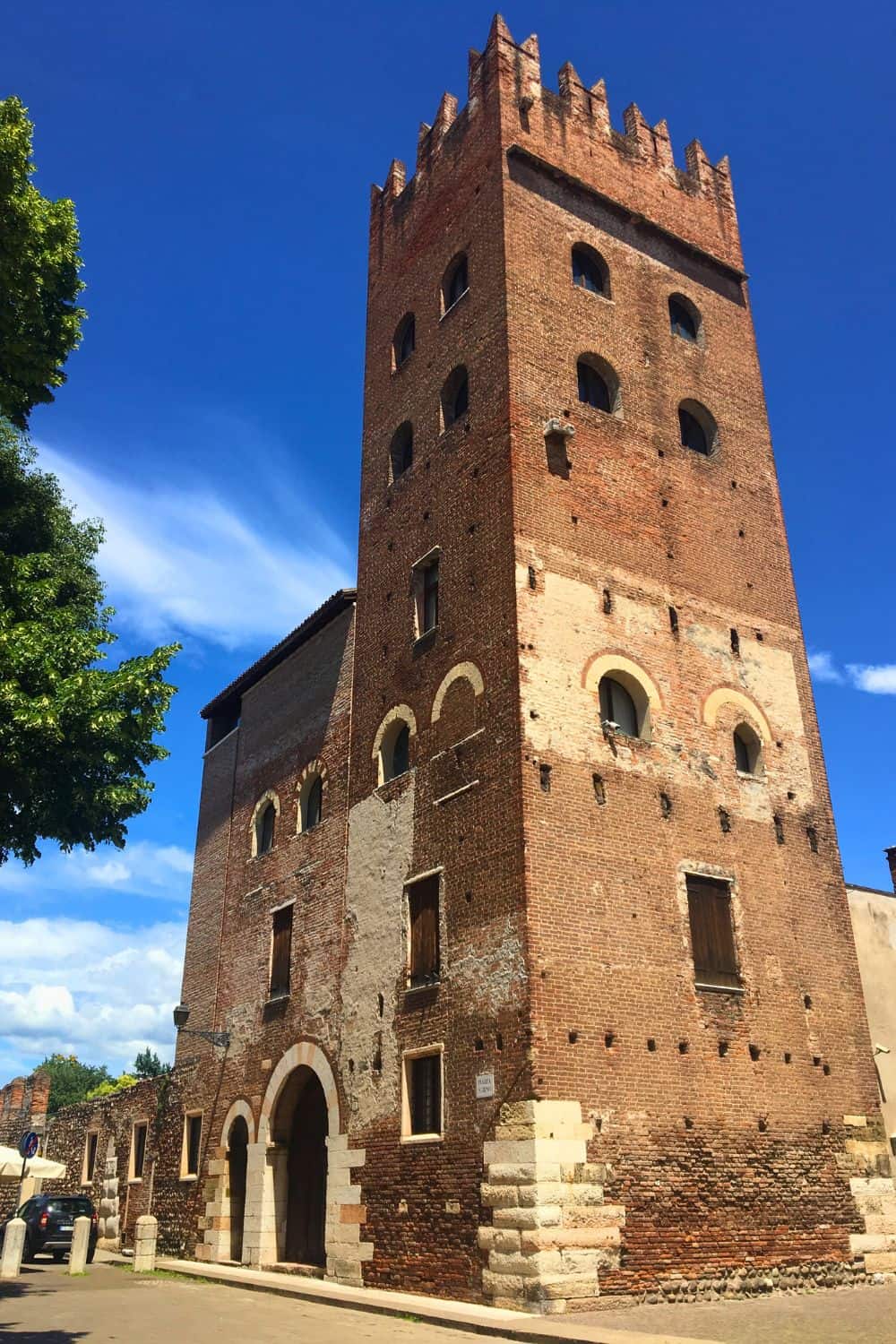 A large brick building that is part of the Basilica di San Zeno Maggiore