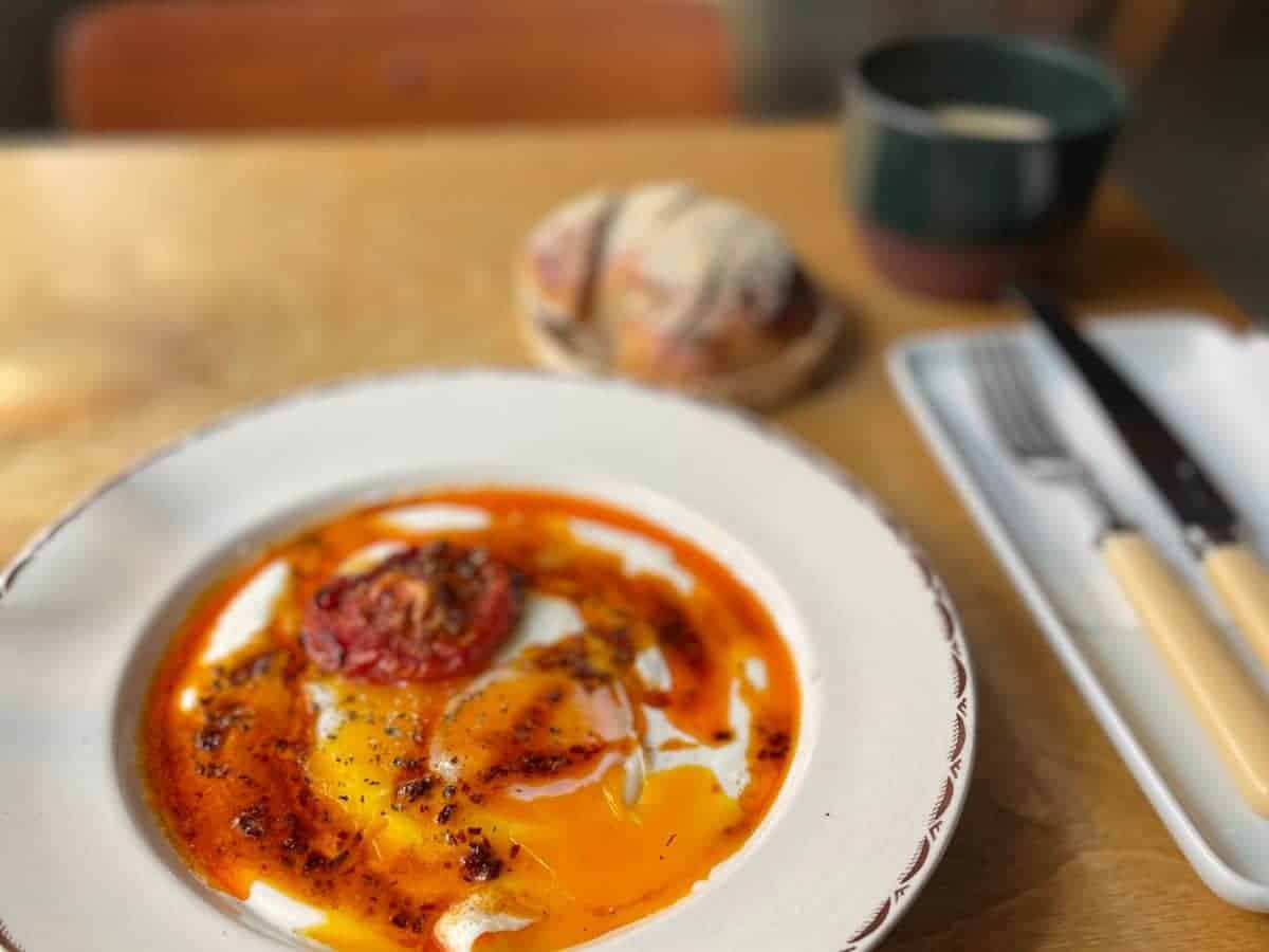 A plate with eggs and tomato sauce