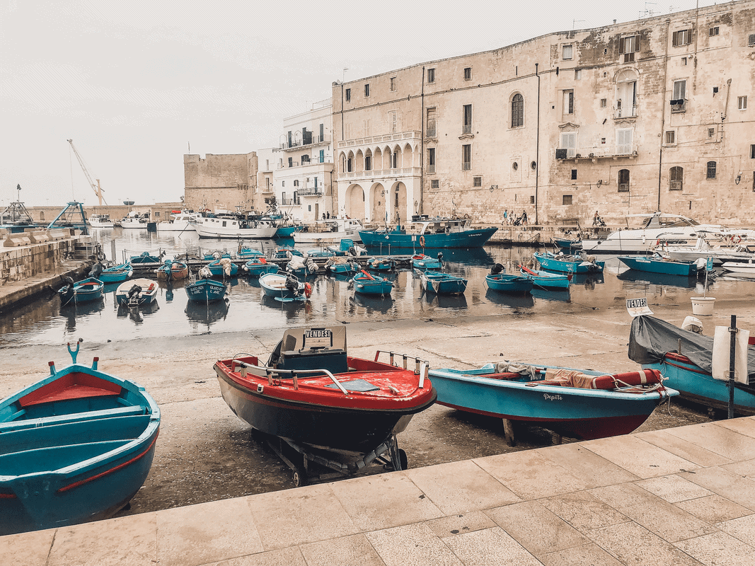 Boats float in the harbor of Monopoli, Italy.