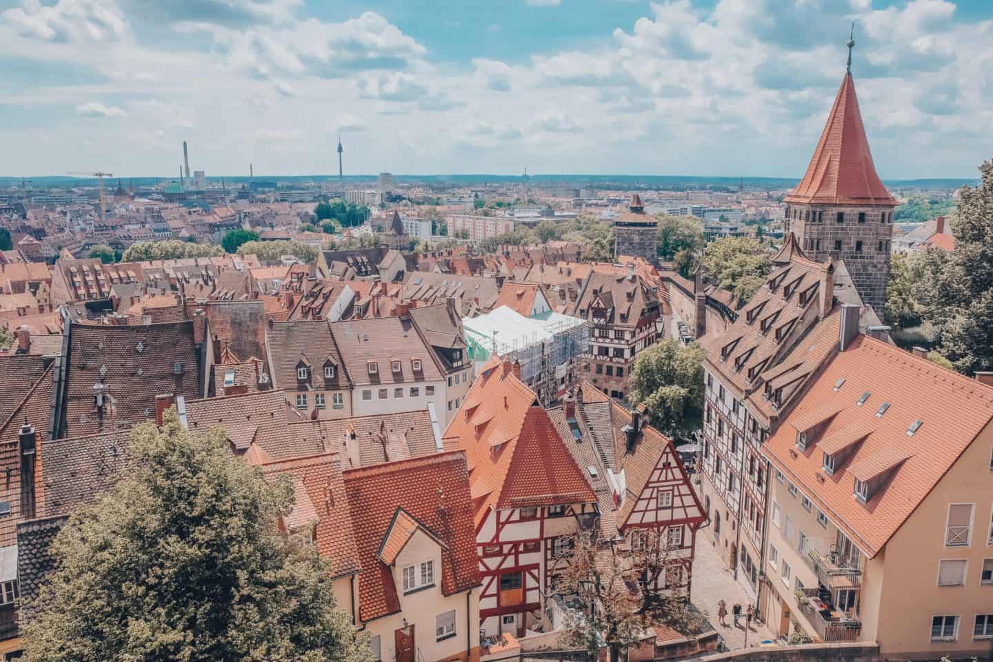 Aerial view of Nuremberg's historic architecture with terra cotta roofs and medieval towers, a perfect starting point for cultural day trips from Nuremberg