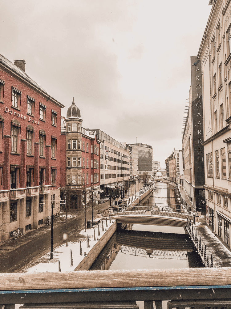 Perfect Copenhagen to Aarhus Itinerary, the city streets and the canal in the snow.