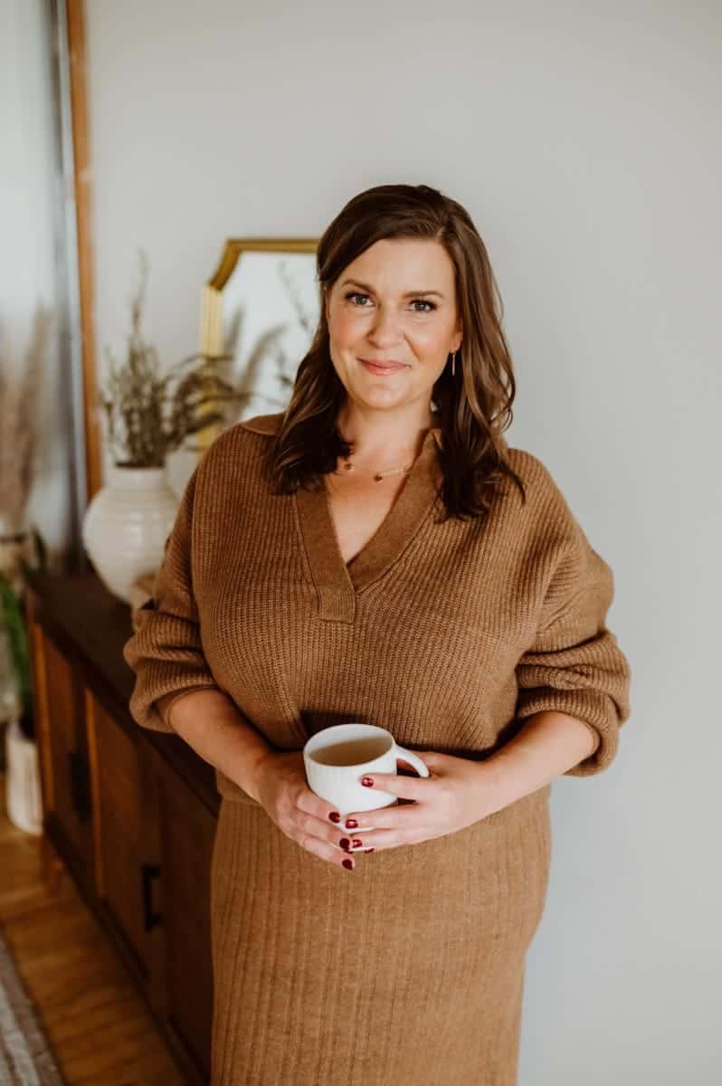Seattle life coach poses with a cup of coffee.