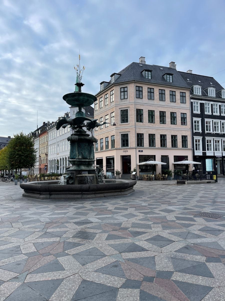 Historic fountain and surrounding buildings in a central Copenhagen square.