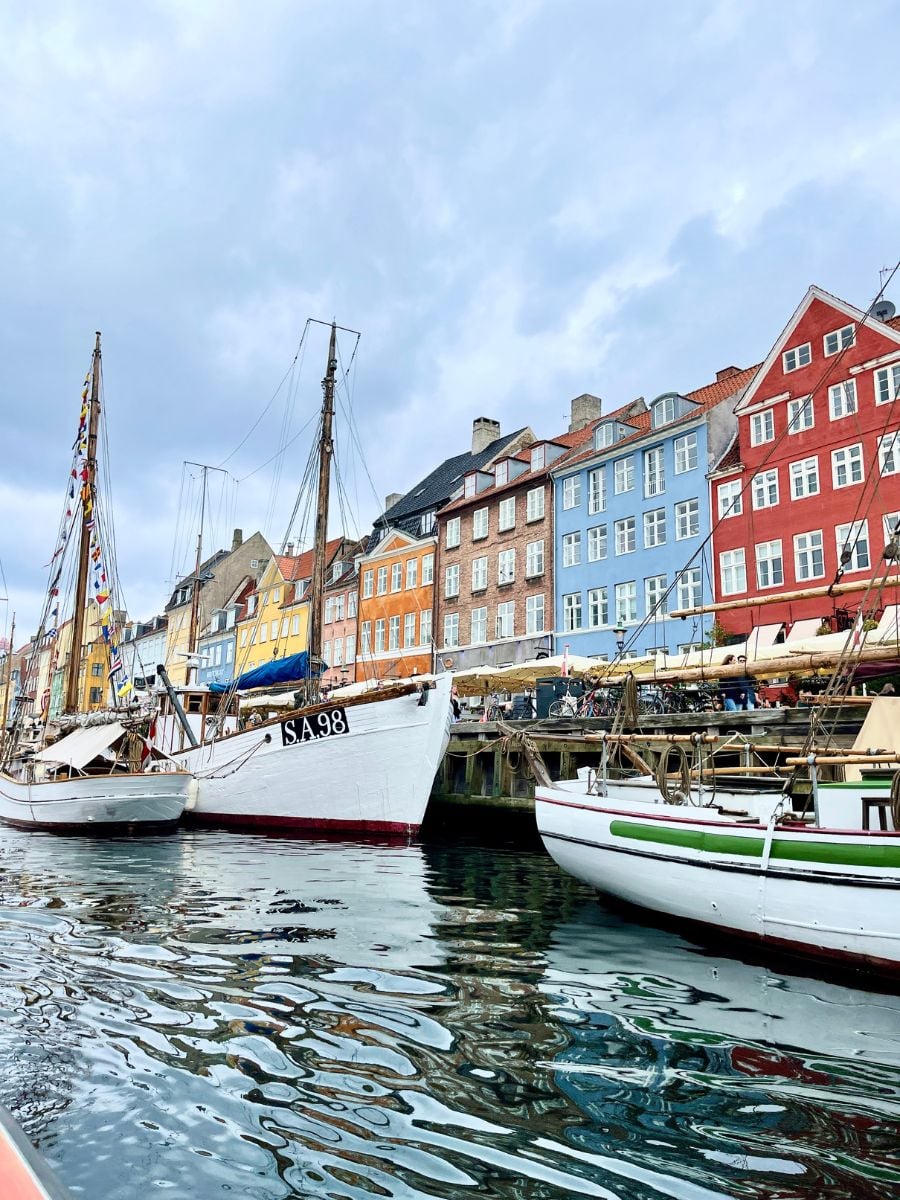 Colorful buildings and boats lining the Nyhavn canal in Copenhagen.