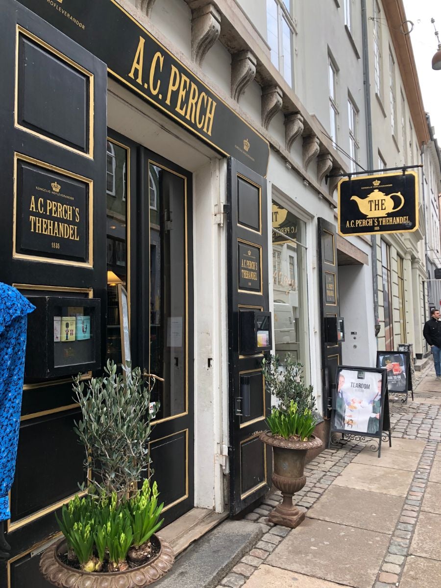 Exterior of A.C. Perchs Thehandel tea shop in Copenhagen with classic black and gold signage.