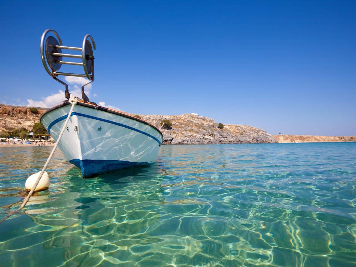 boat in the water of the aqua blue waters of the Symi island Beaches
