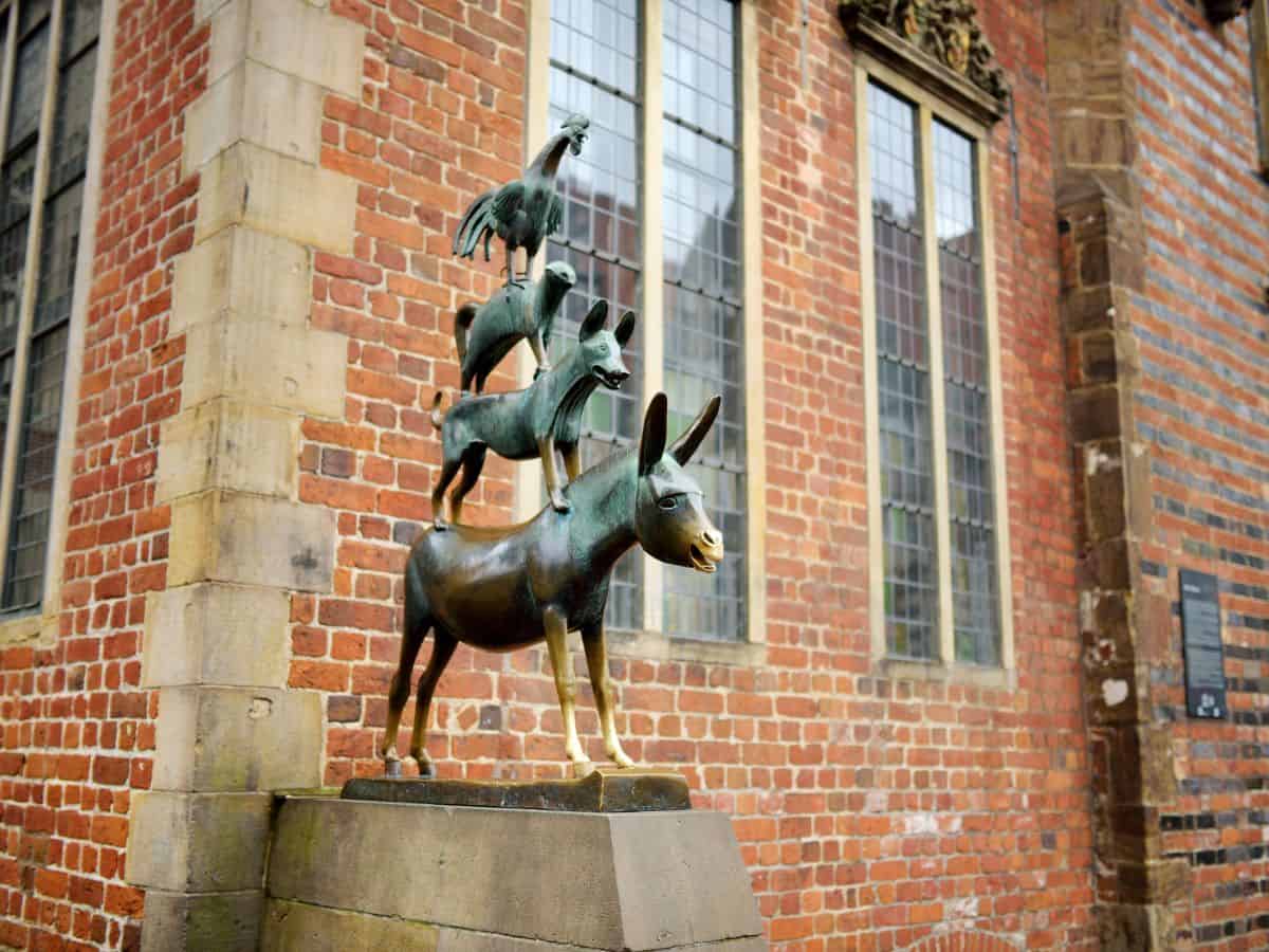 The "Town Musicians of Bremen" statue, depicting the famous fairy tale by the Brothers Grimm. The sculpture shows four animals stacked atop one another: a donkey at the bottom, a dog standing on the donkey, a cat perched on the dog, and a rooster crowing at the top.