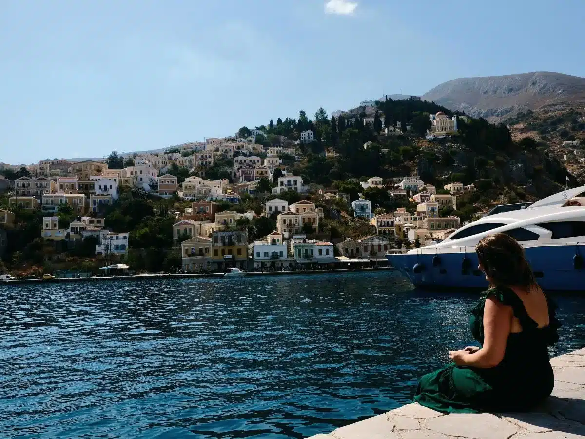 A Woman in Symi sitting by the water