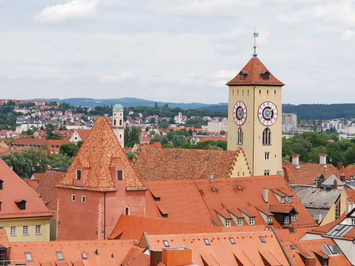 Overlooking the rooftops of Regensburg, with the historic clock tower standing tall, a view that captures the essence of Bavaria on a day trip from Nuremberg.