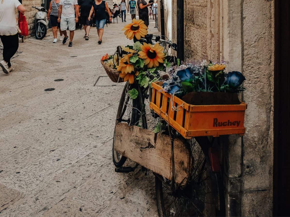 Wooden Bicycle in Bari with flowers in the basket