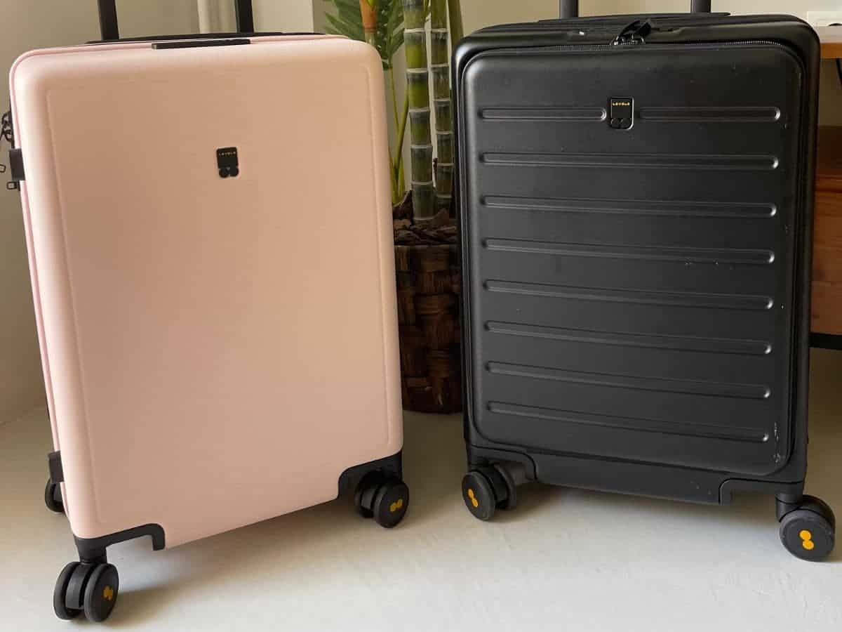 Comparing pink Textured level8 suitcase to the black Road Runner Carry-on Suite Case