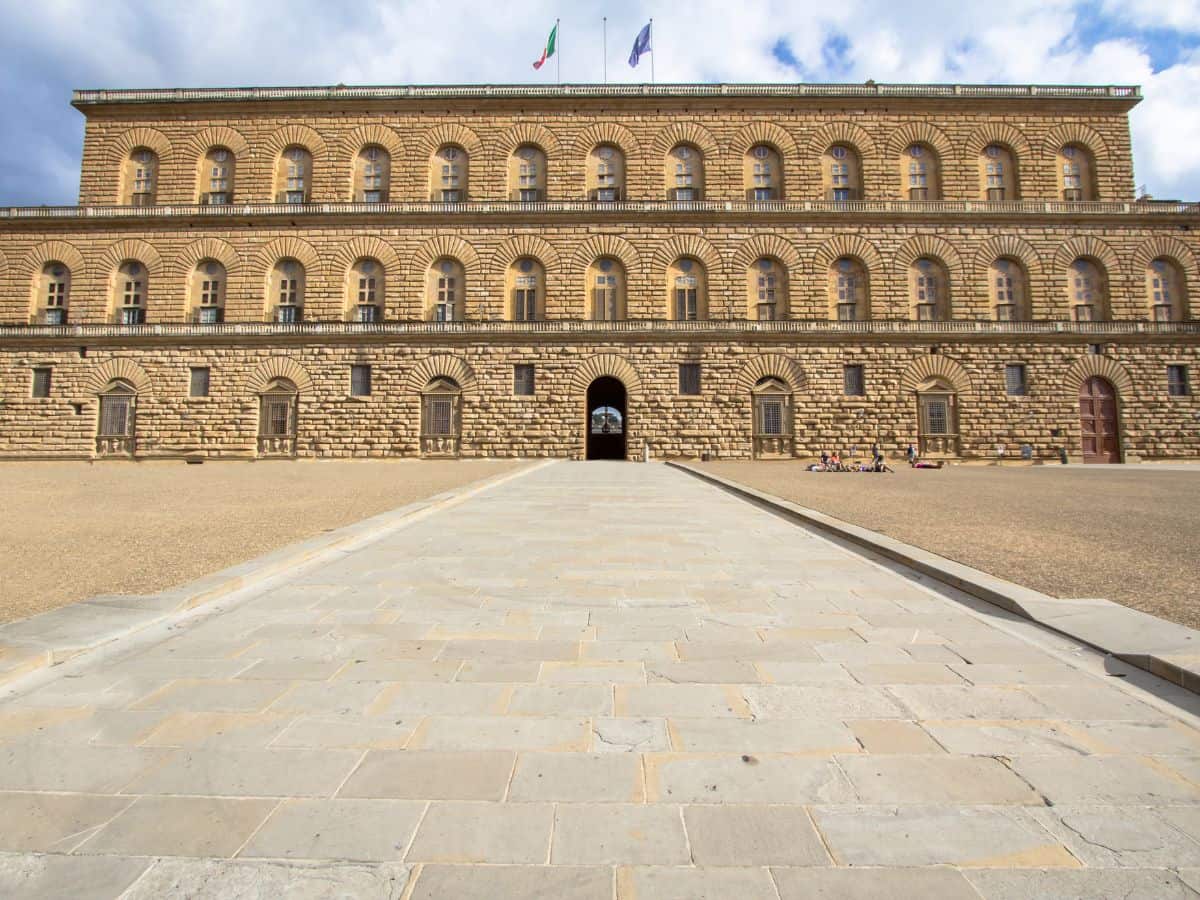 The Pitti Palace in Florence. An old brick building with 3 levels.