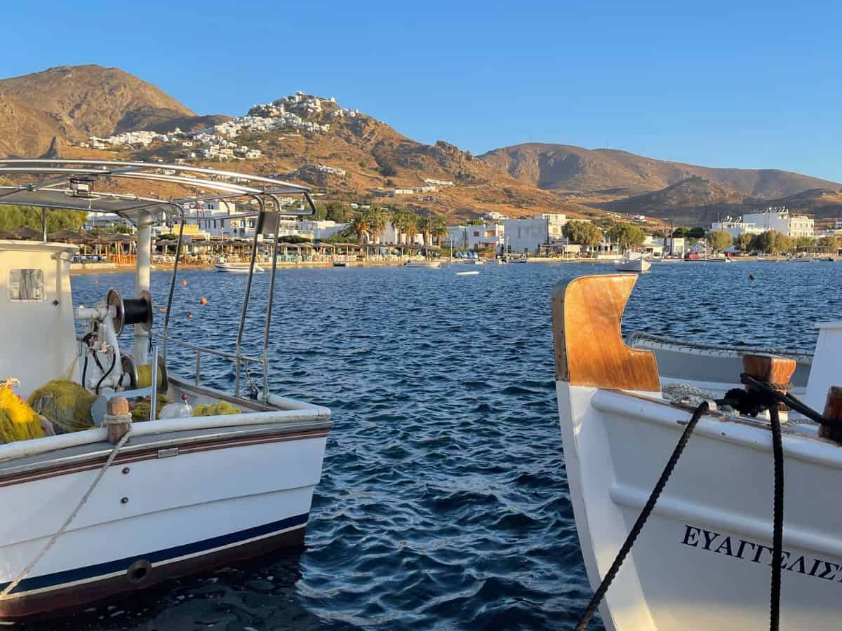Ocean with 2 boats in and the backdrop of the greek island of Serifos