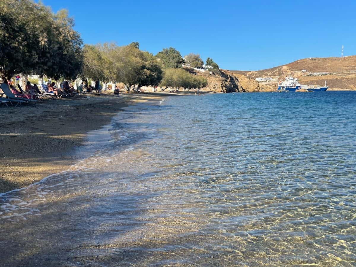 A view of the island of Serifos beach with the ocean, and trees lining the beach