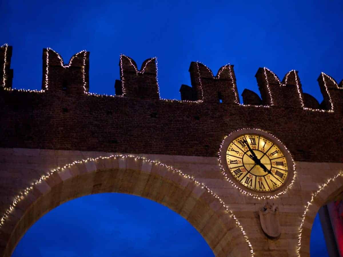 Medieval gate in Verona decorated with Christmas lights.