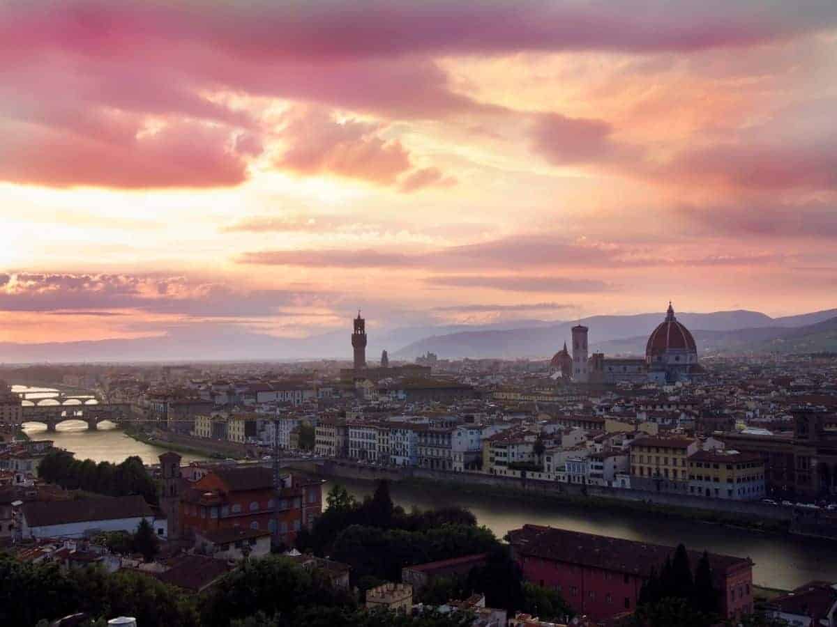 A pink sky sunset looking over the city of Florence from Piazzale Michelangelo