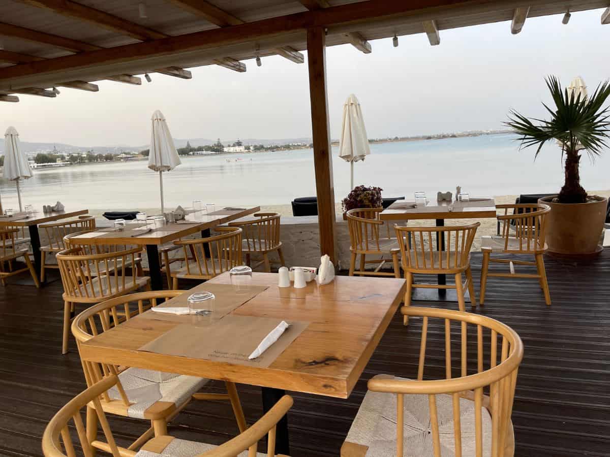 A restaurant by the sea in Naxos. Empty table with the ocean in the distance.