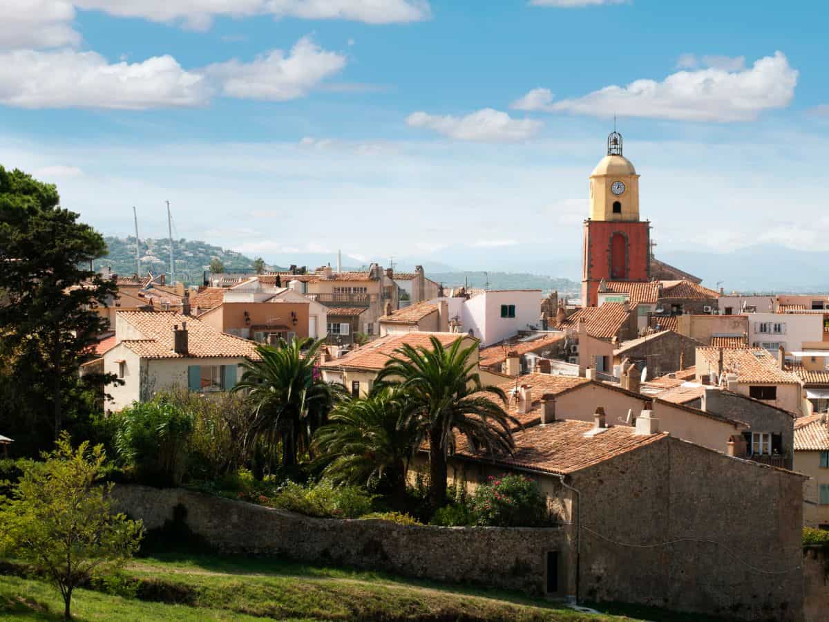 French town of Saint Tropez Palm trees and buildings in the distance.