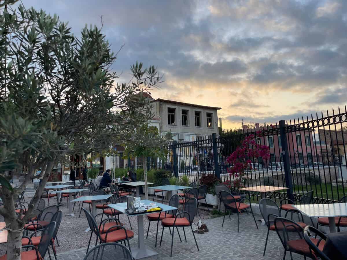 A sunset sky with empty table and chairs in December in Athens