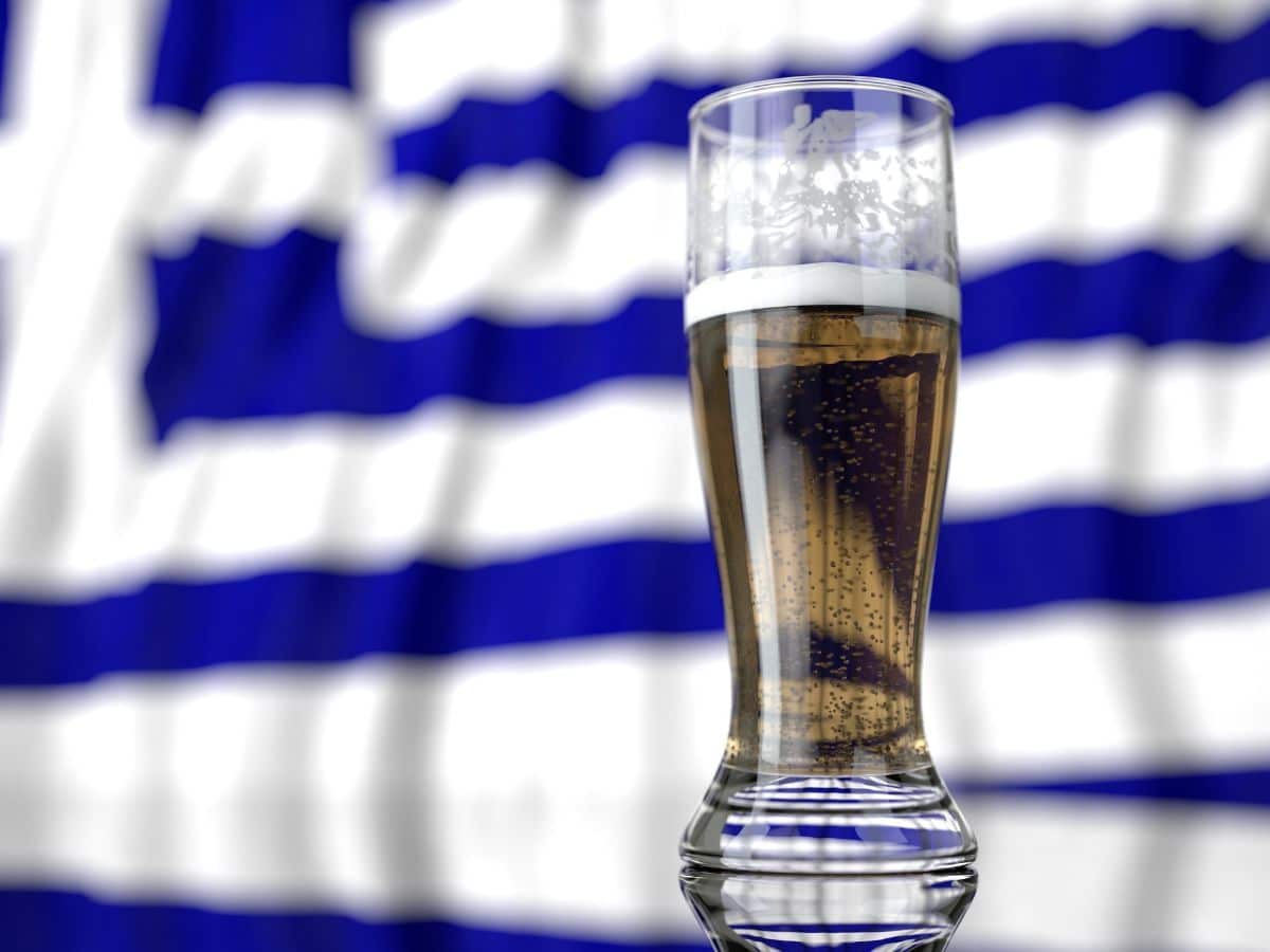 a beer in front of a greek flag. Are you of legal drinking age in greece?