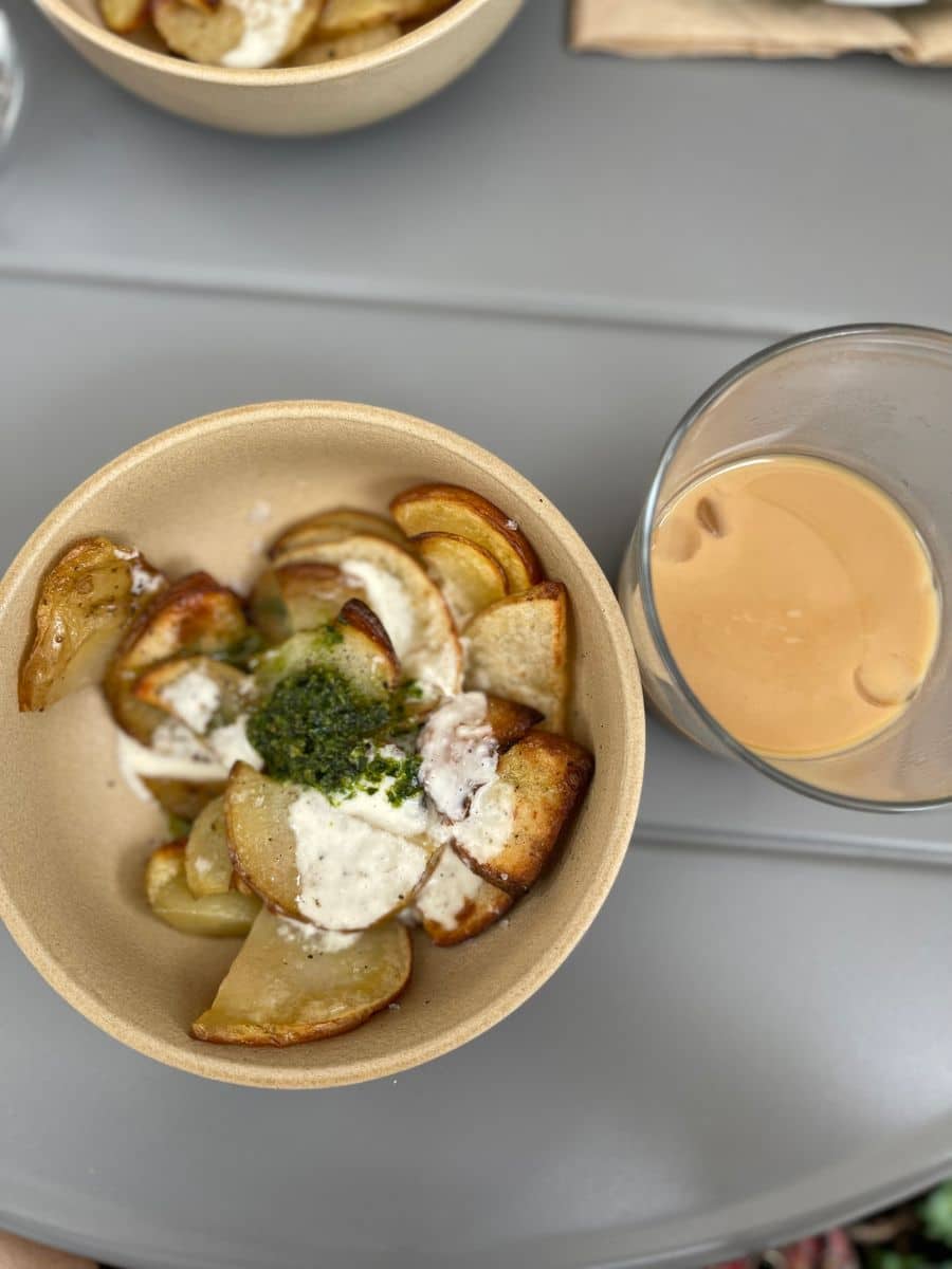 Potatoes in a bowl and iced coffee