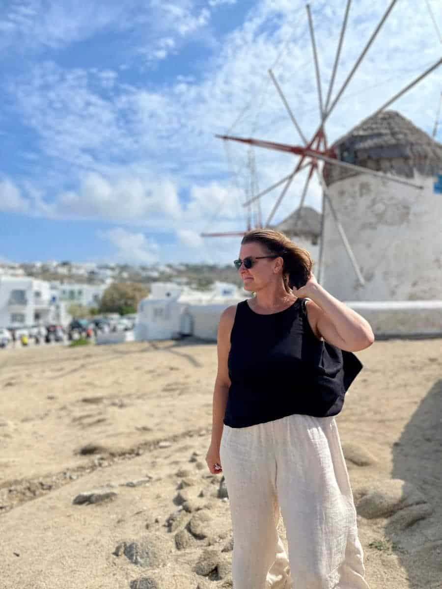 a woman in Mykonos with the windmills in the background