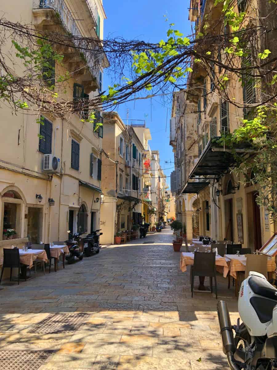 The old cobble stone streets of Corfu lined with restaurants and old buildings