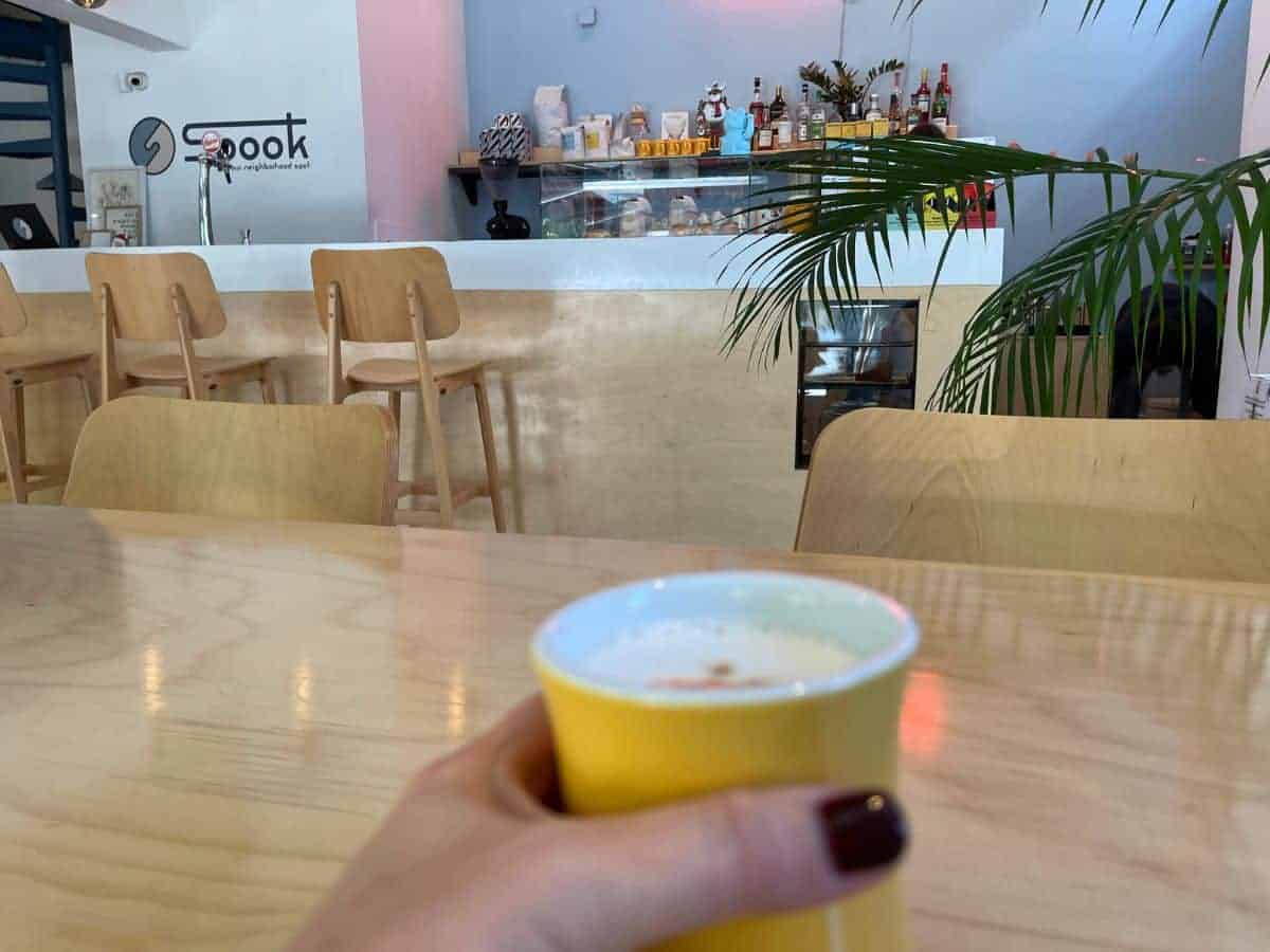 a latte in my hand at the Cafe Spook, in Athens, Greece