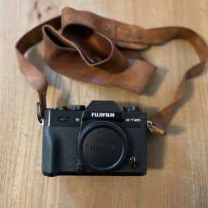 A Fujifilm X-T20 camera with a brown leather strap