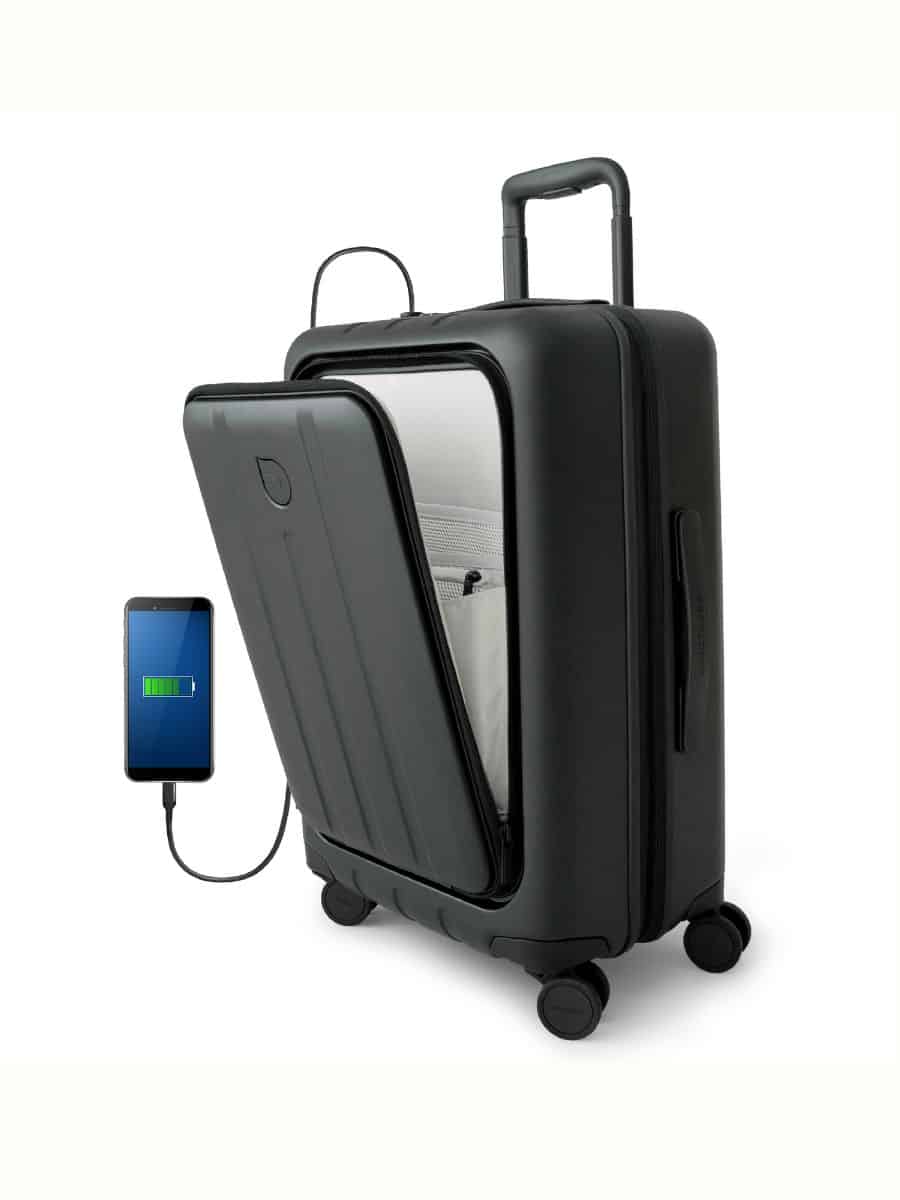 A close-up of a robust black carry-on suitcase designed for the tech-savvy female traveler, showcasing a sturdy exterior with a hint of a padded laptop compartment visible through the half-open front section, embodying the best carry-on luggage with a laptop compartment for women.