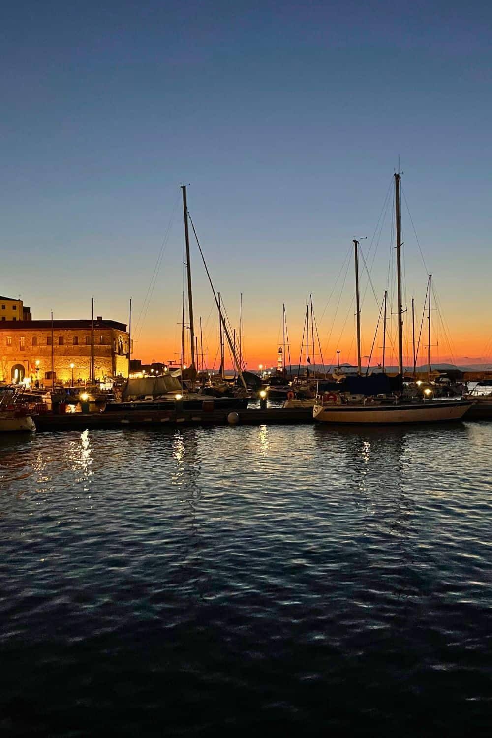 Chania harbor at sunset with boats in the water