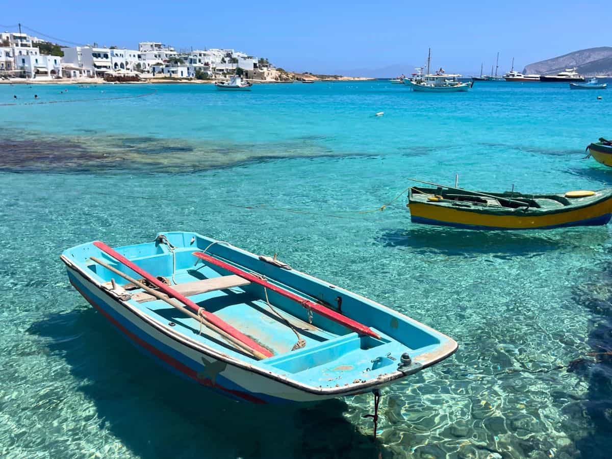 Crystal Blue waters on Greek Island with small rowing boat.