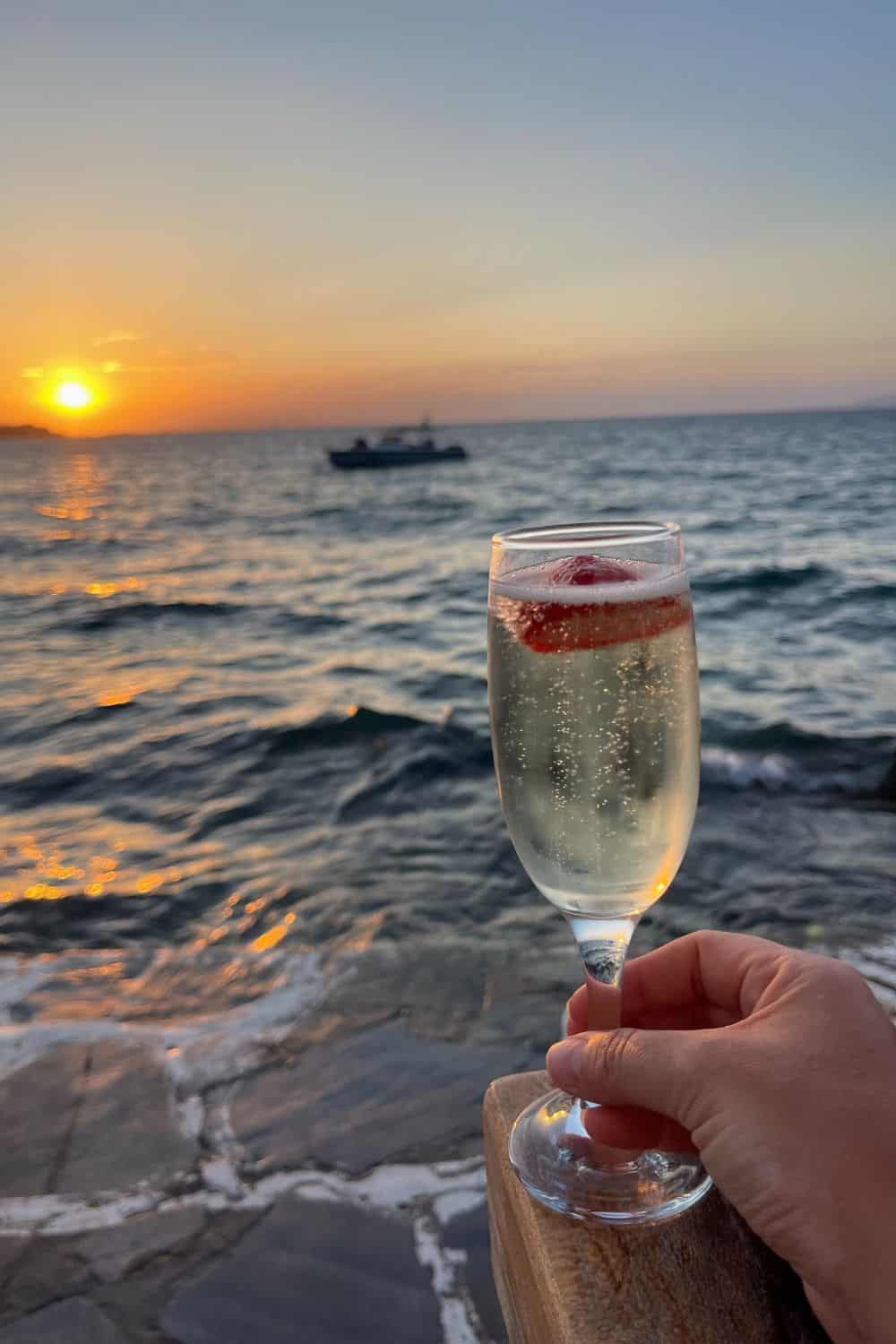A glass of champagne at sunset in Mykonos. 