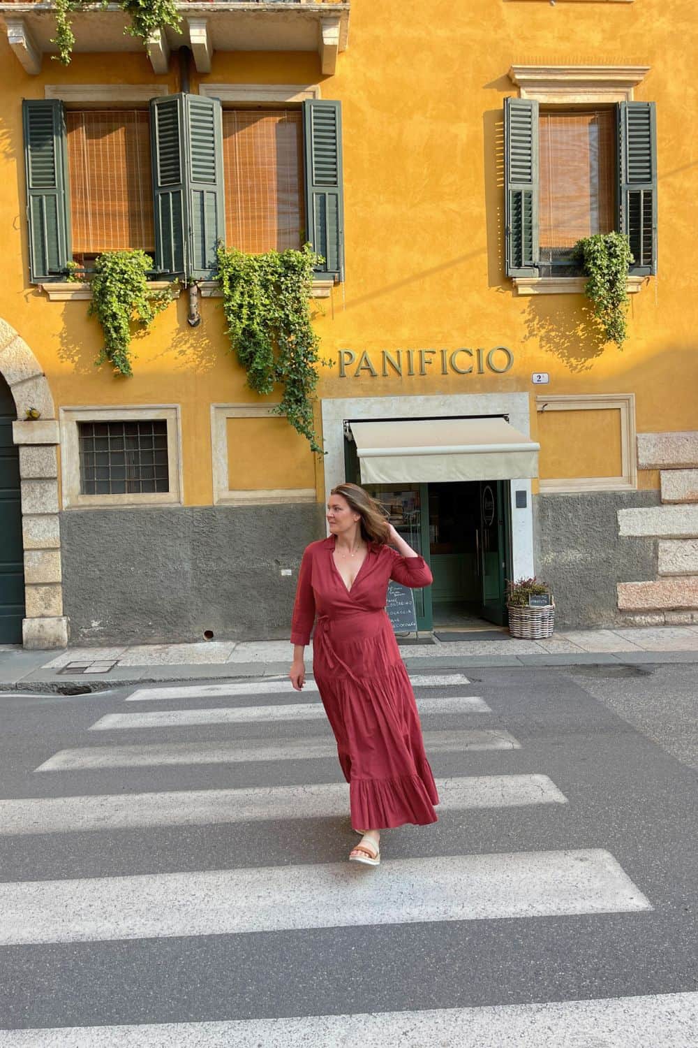 A woman crossing the streets in Verona