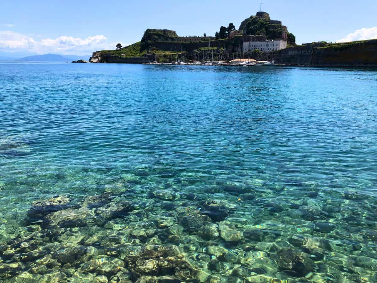Up close of the ocean floor in Corfu with the fortress high on the hill in the background. 