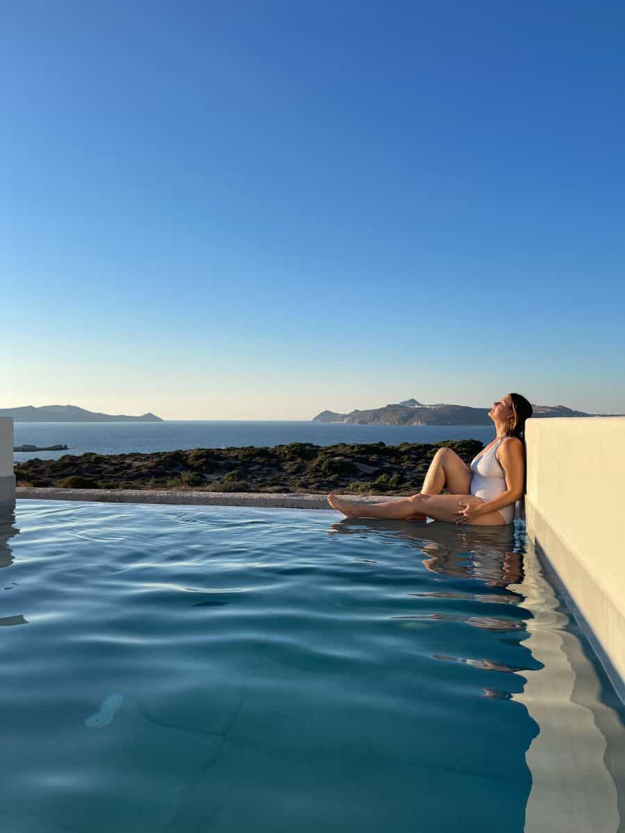 Woman sitting on the edge of the pool in Milos Greece