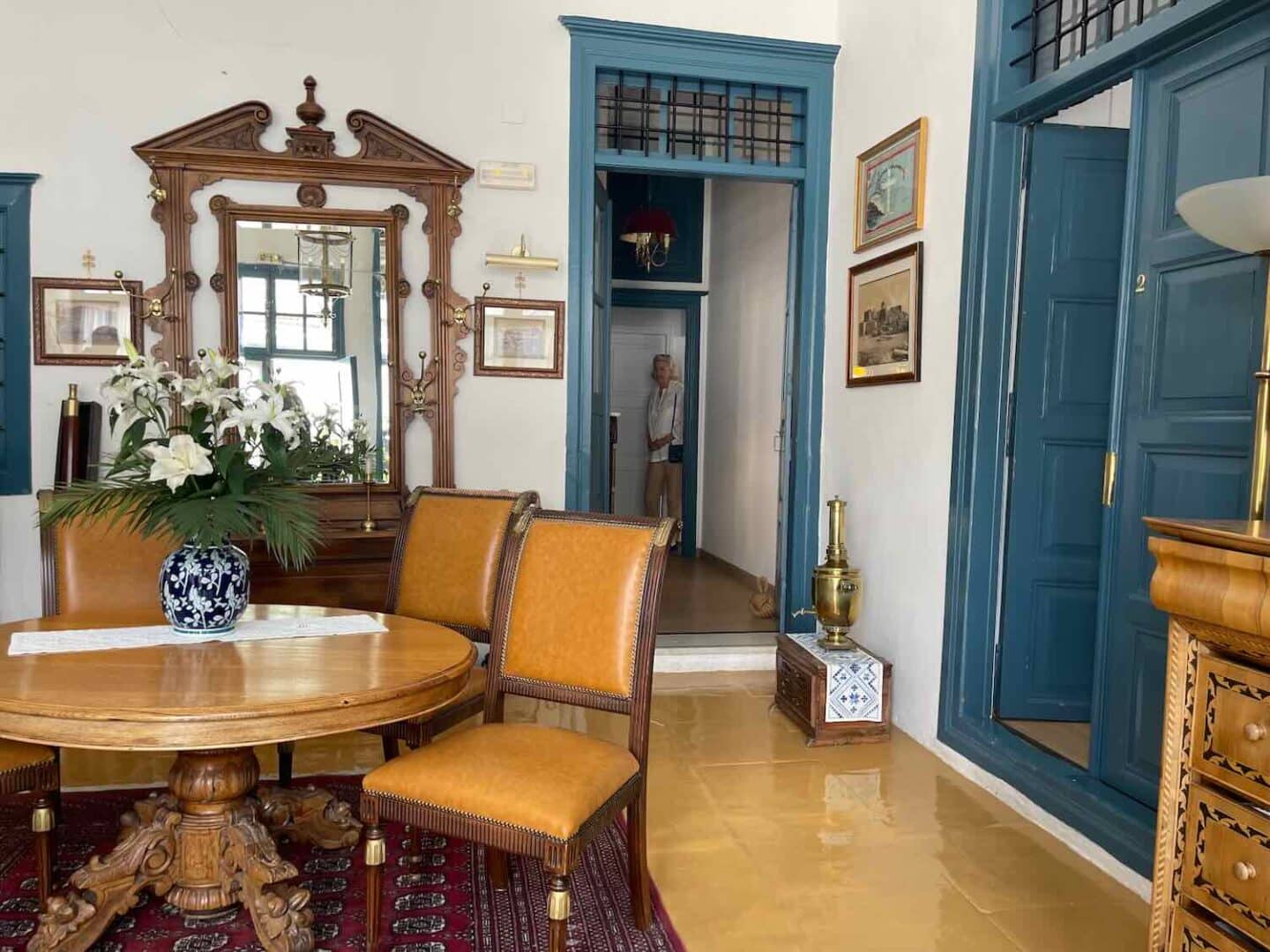 Traditional decor in the Orloff hotel's lobby in Hydra, with ornate wooden furniture and a classic blue and white palette, reflecting Greek heritage.
