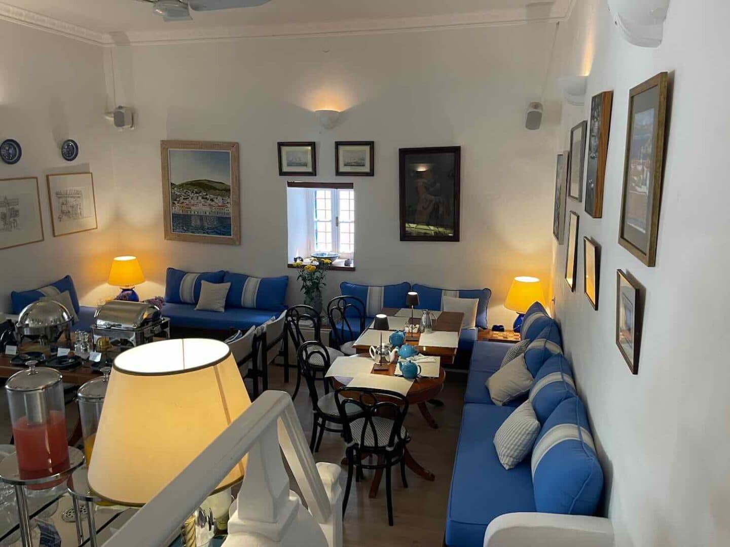Cozy and elegant interior of the Orloff boutique hotel in Hydra, featuring blue and white nautical-themed decor, inviting guests for a relaxing stay.