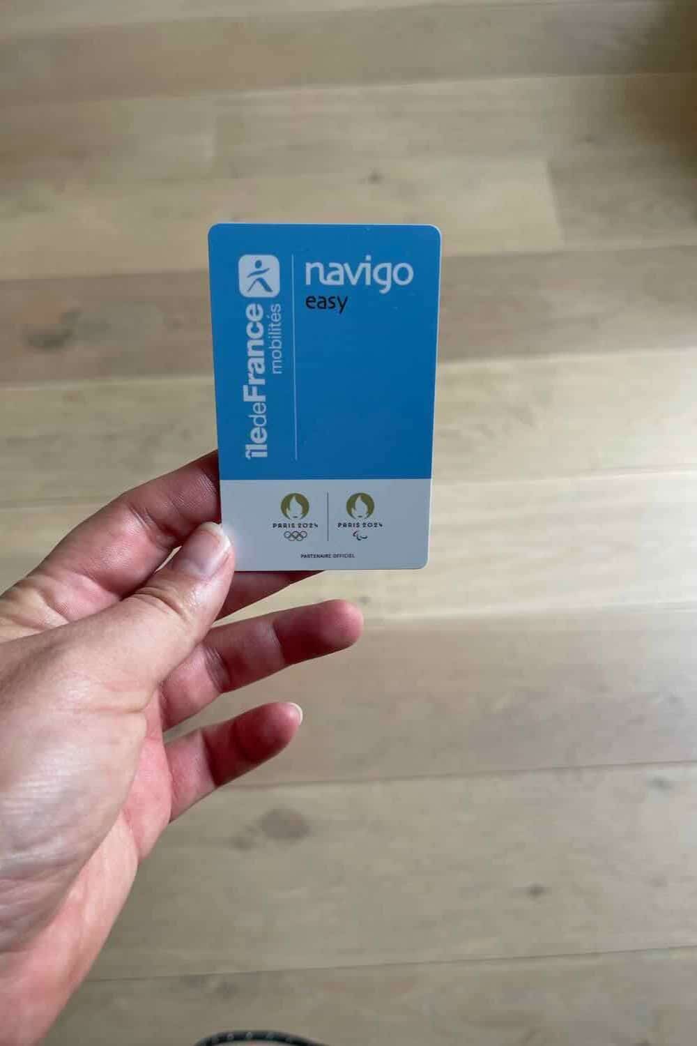 A close-up of a hand holding a Navigo Easy metro card, a convenient tool for solo travelers navigating public transport in Paris.