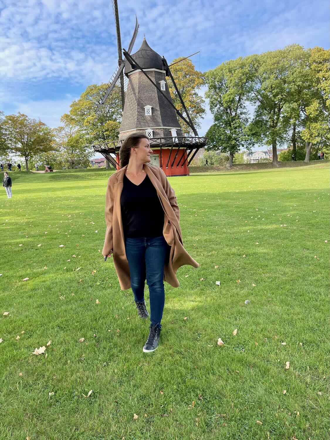 A woman at Kastellet with windmill behind her. 