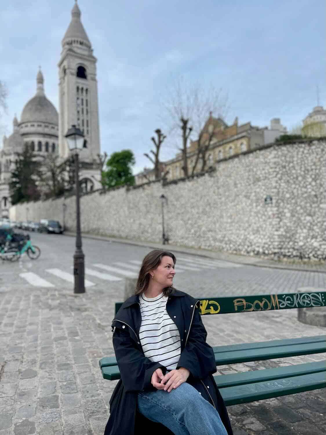 woman sitting alone on a bench in Paris.