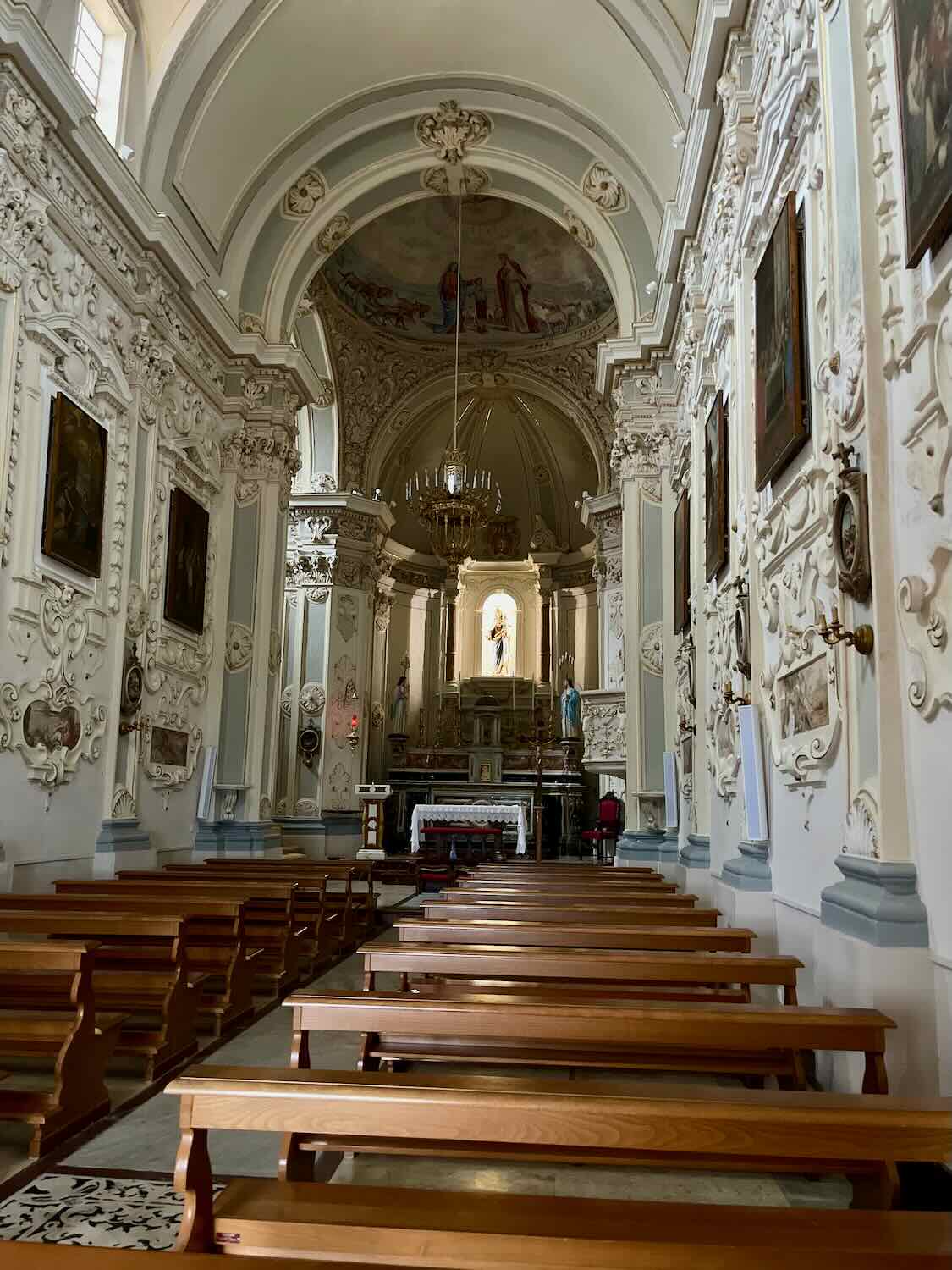 Interior of the church with wooden benches. 