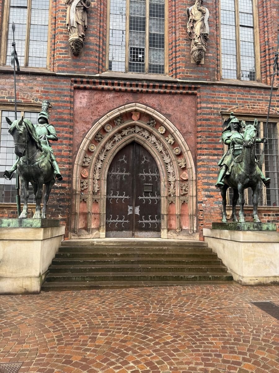 Ornate Gothic doorway flanked by knight statues in Bremen.