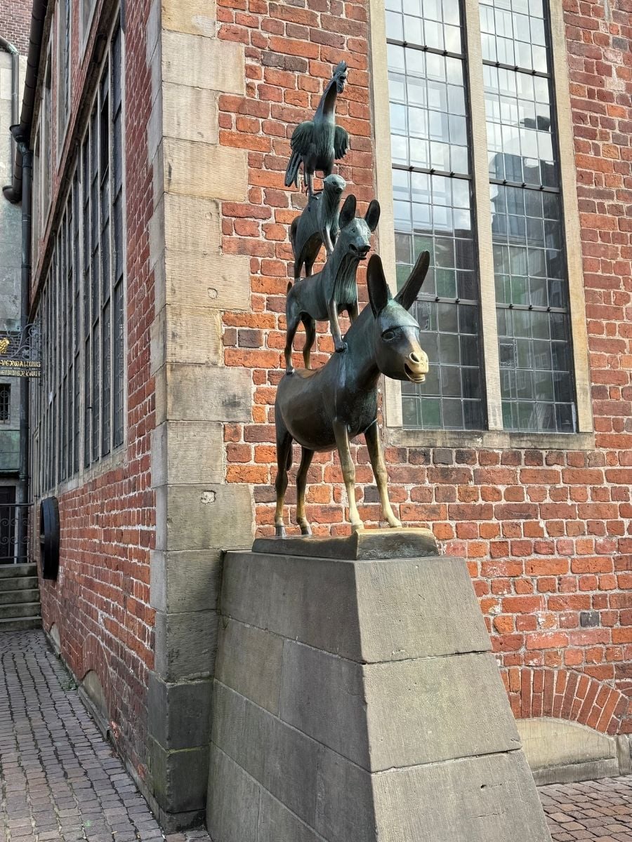 Famous Bremen Town Musicians bronze statue of donkey, dog, cat, and rooster stacked on each other.