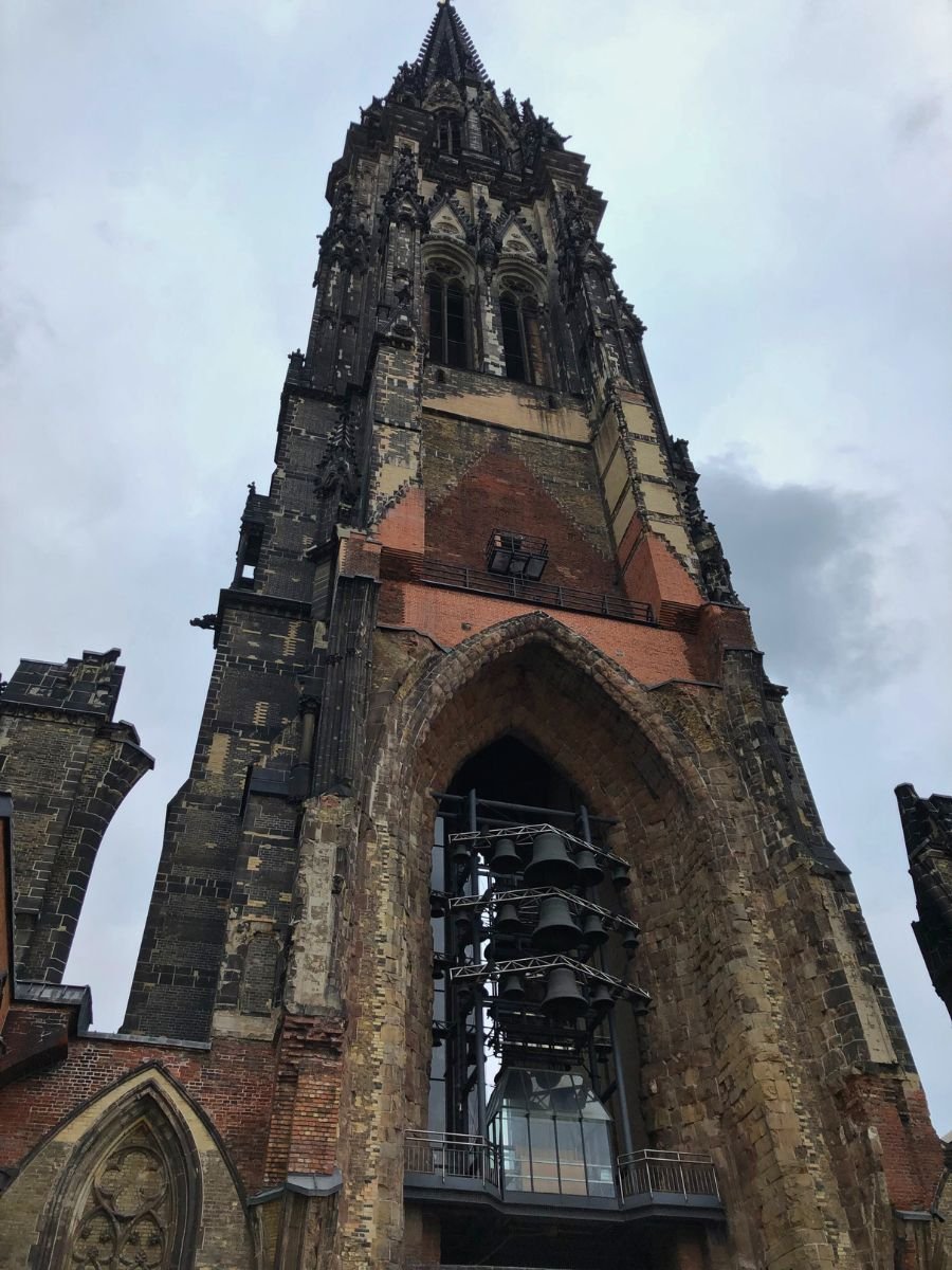 The ruins of St. Nikolai Memorial in Hamburg with its tall Gothic tower and exposed belfry.