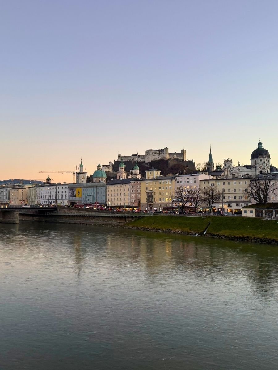 Scenic skyline of Salzburg along the river during daytime.