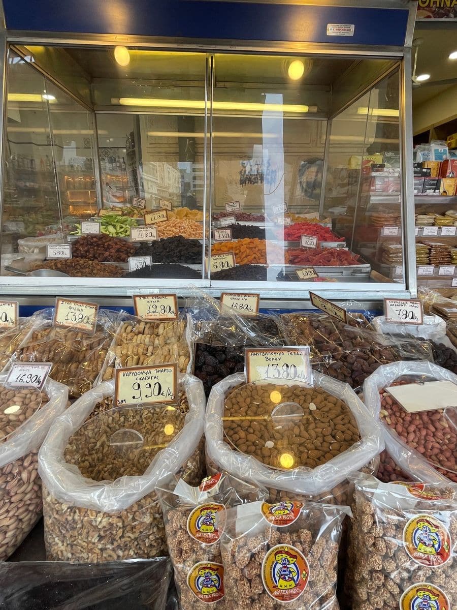 Dried fruits, nuts, and spices displayed at a stall in Athens Central Market during a food tour.