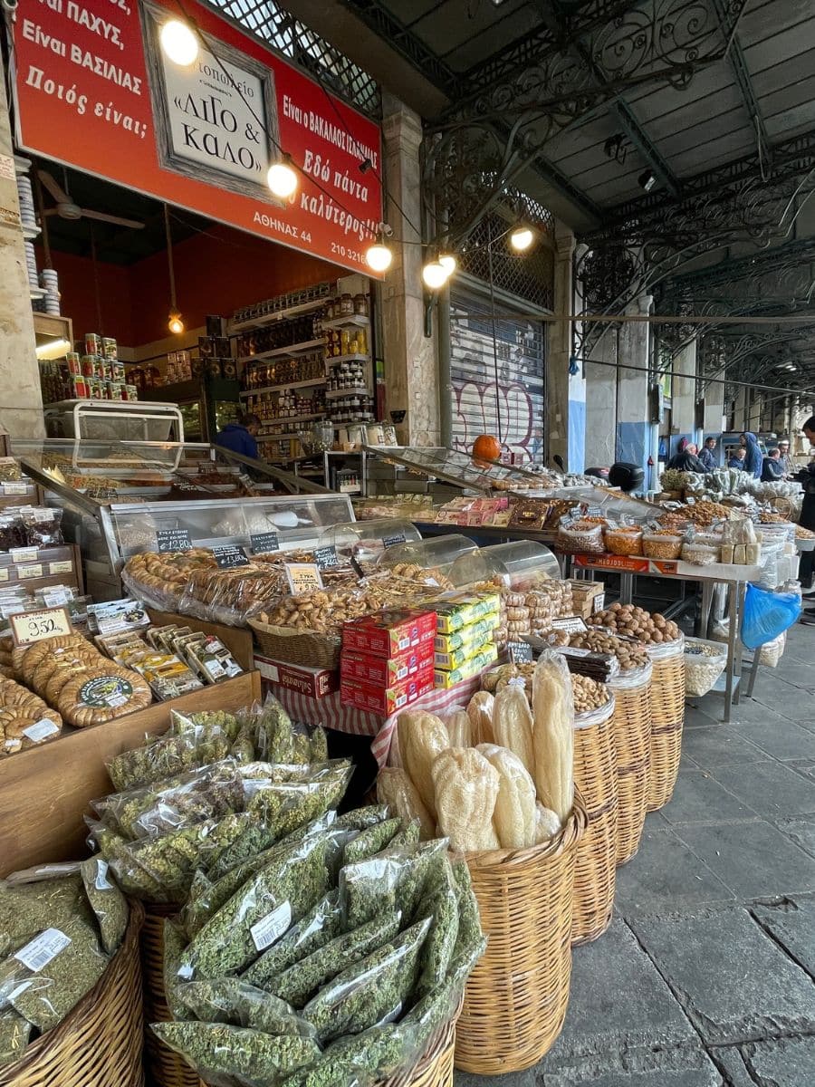 Greek herbs, nuts, and local products at a vendor stall in Athens Central Market on a food tour.