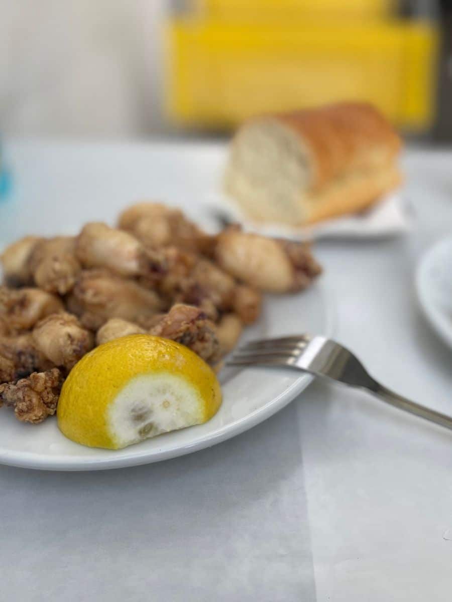 Fried calamari with lemon served as a seafood tasting on an Athens food tour.