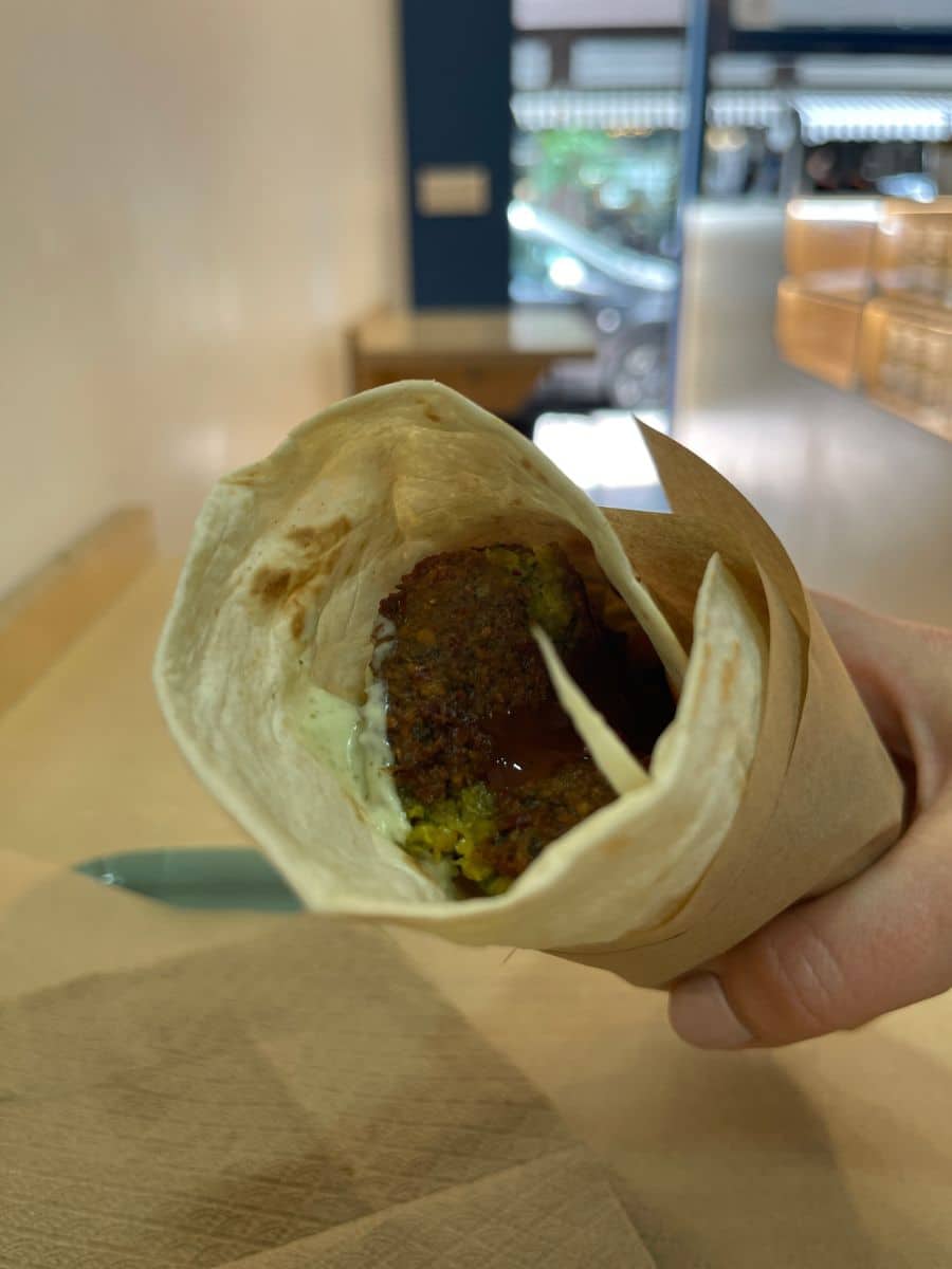Fresh falafel wrap with tahini sauce from a local street food stop on an Athens food tour.